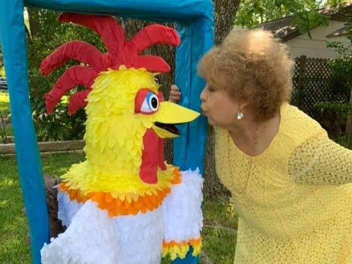 Mary Coronado kissing one of her piñatas.